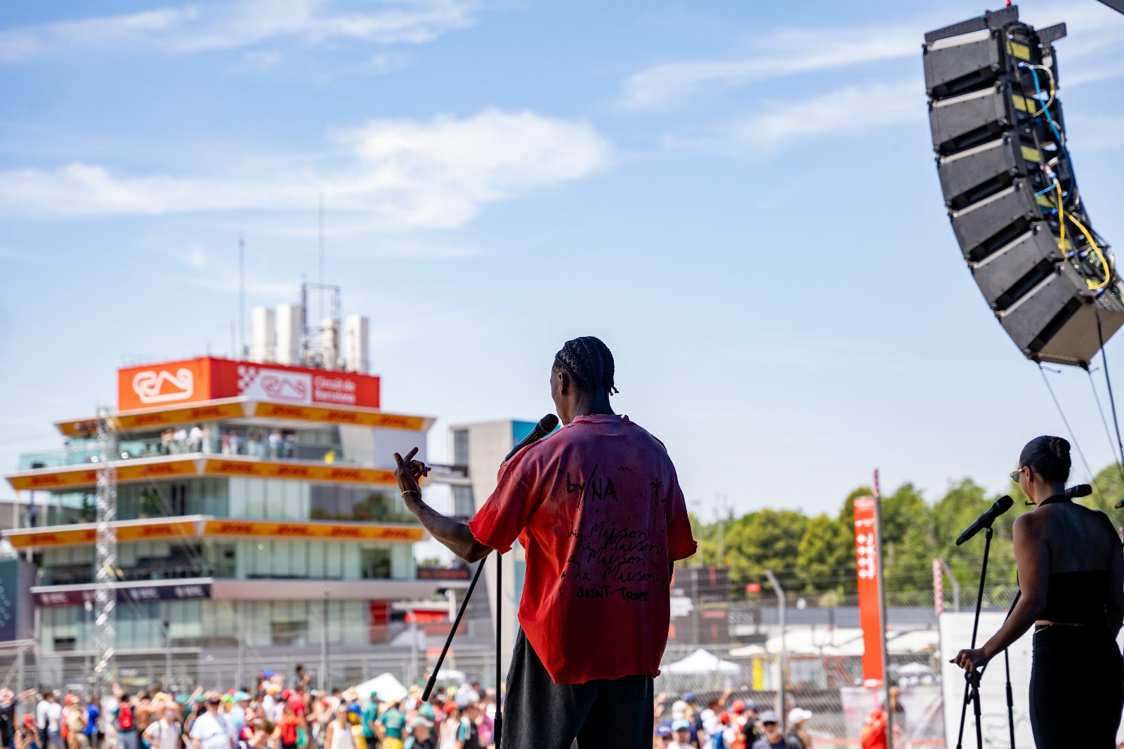 Vocalist performing with the Circuit de Barcelona-Catalunya control tower behind